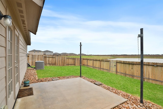 view of patio / terrace featuring a water view and central AC