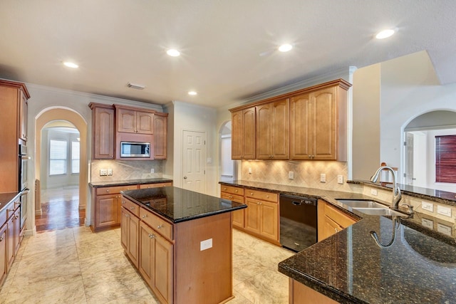 kitchen with dishwasher, stainless steel microwave, a center island, sink, and dark stone counters