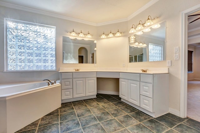 bathroom with a bath, vanity, a wealth of natural light, and ornamental molding