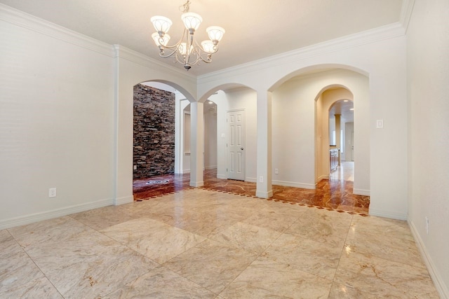 spare room with crown molding and a chandelier