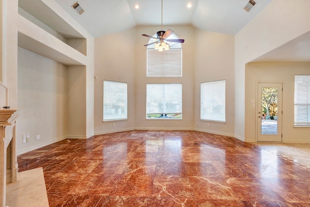 unfurnished living room featuring a fireplace, high vaulted ceiling, a wealth of natural light, and ceiling fan