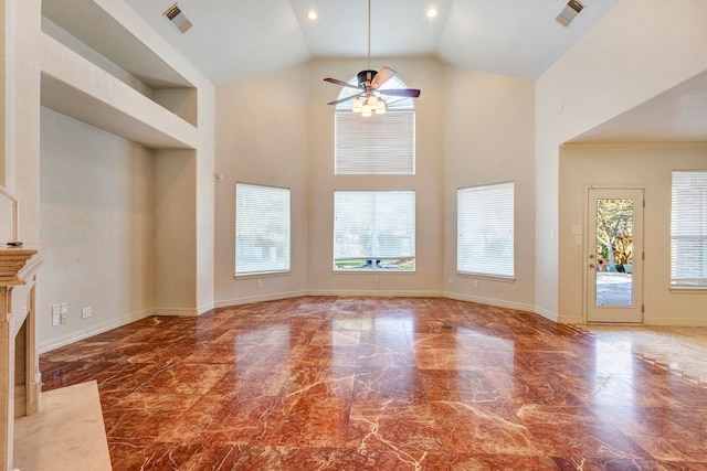 19238 Clear Sky Dr, Humble, TX 77346 - unfurnished living room with visible vents, a ceiling fan, marble finish floor, and a high ceiling