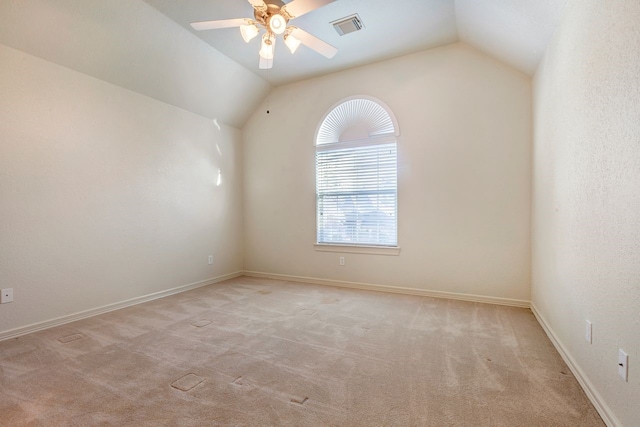 carpeted empty room with vaulted ceiling and ceiling fan