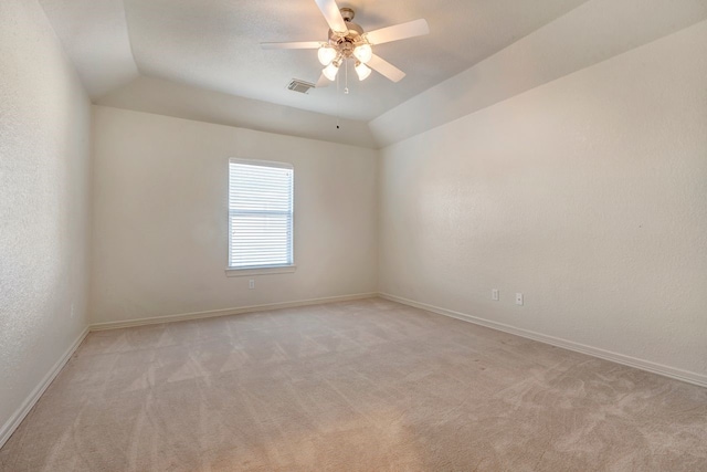 empty room featuring light carpet, ceiling fan, and lofted ceiling