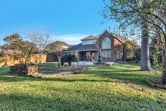 19238 Clear Sky Dr, Humble, TX 77346 - view of front of house featuring fence, brick siding, and a front yard