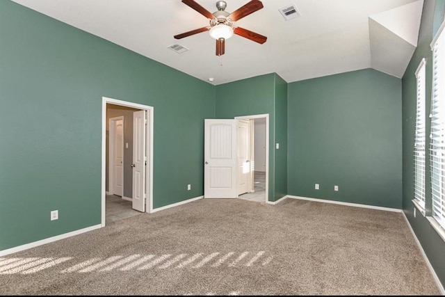 unfurnished bedroom featuring ceiling fan, light colored carpet, and lofted ceiling