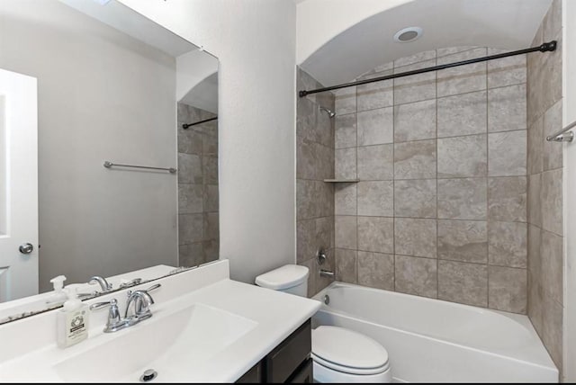 full bathroom featuring toilet, vanity, and tiled shower / bath