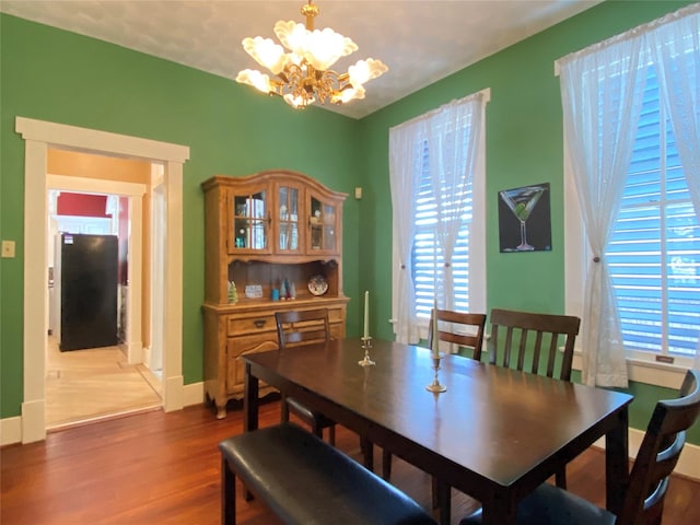 dining area featuring a chandelier and hardwood / wood-style flooring