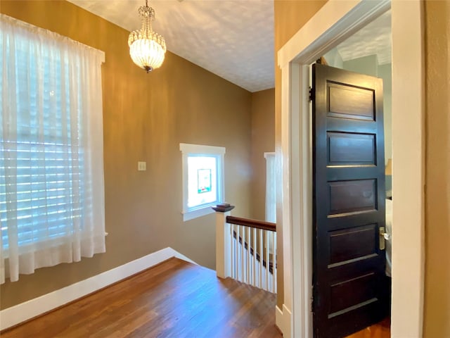 interior space featuring dark wood-type flooring and a notable chandelier