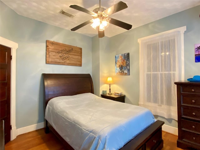 bedroom featuring ceiling fan and dark hardwood / wood-style flooring