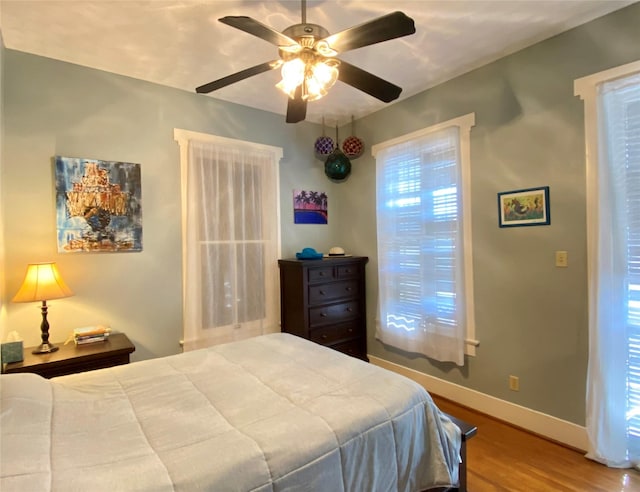 bedroom featuring wood-type flooring and ceiling fan