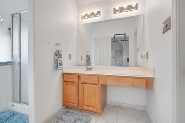 bathroom with vanity and a shower with door