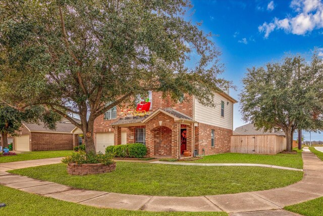 view of property featuring a garage and a front lawn