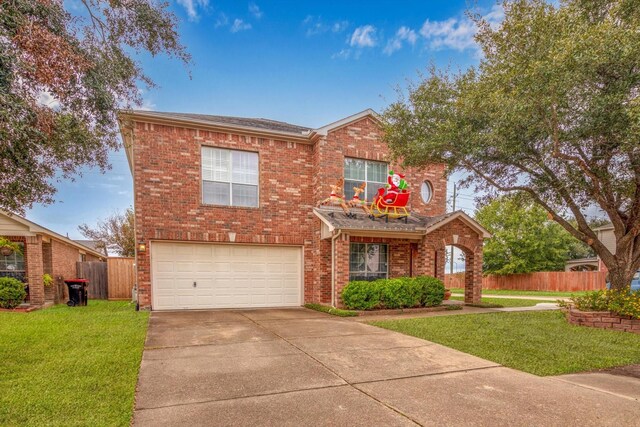 view of front of house with a garage and a front yard