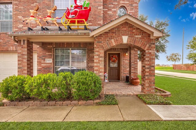 view of exterior entry with a lawn