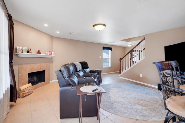 tiled living room with a tile fireplace