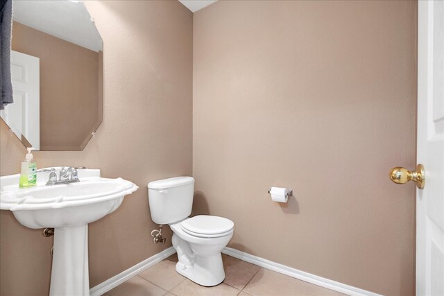 bathroom with tile patterned flooring and toilet