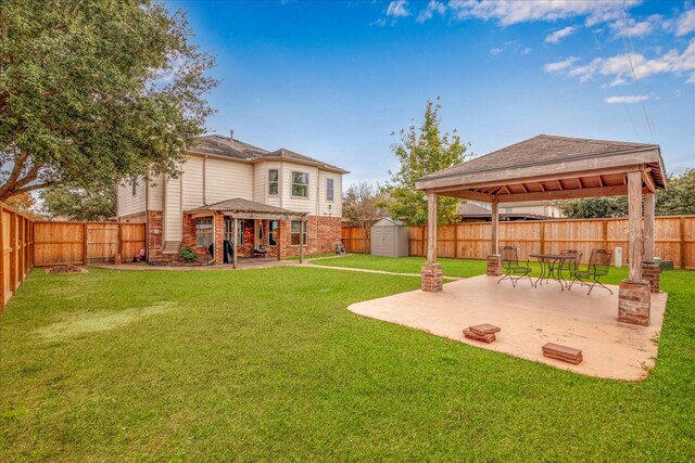 view of yard featuring a storage shed and a patio