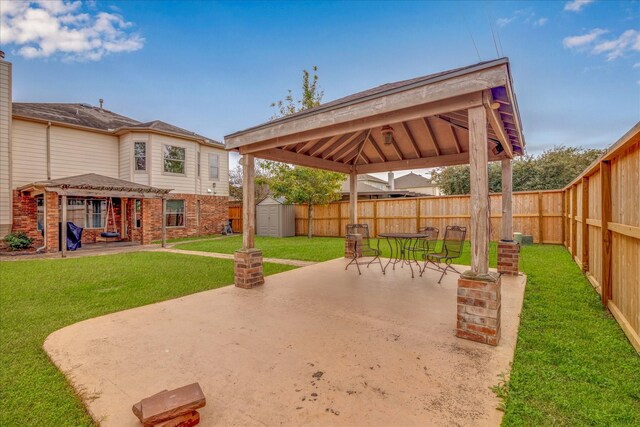 view of patio / terrace with a gazebo and a shed