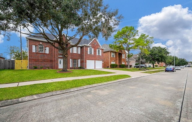 view of front of property with a front yard and a garage