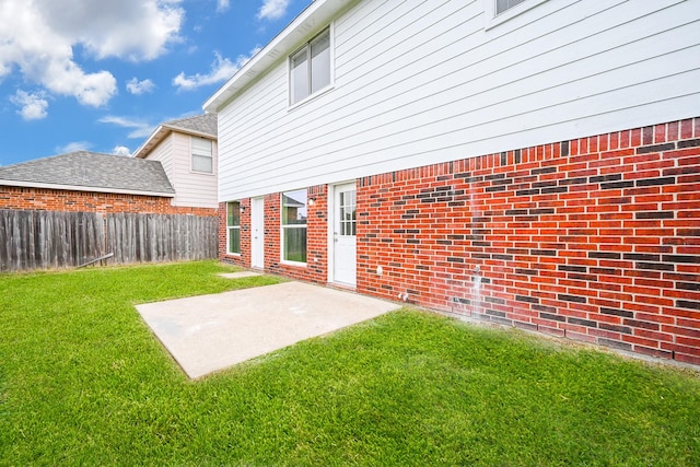 rear view of house featuring a patio area and a yard