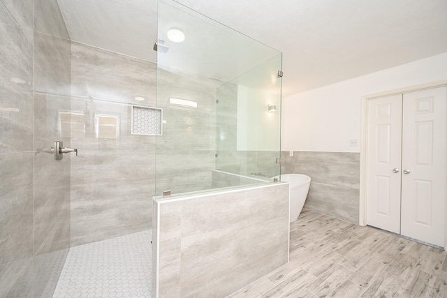 bathroom with plus walk in shower and tile walls