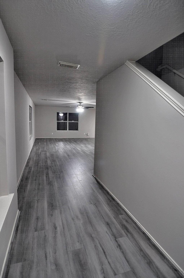 empty room with a textured ceiling and hardwood / wood-style floors