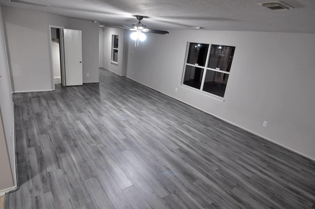 empty room with ceiling fan, a textured ceiling, and hardwood / wood-style flooring