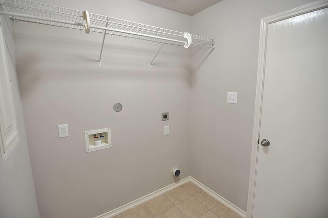 clothes washing area with light tile patterned floors, gas dryer hookup, hookup for a washing machine, and hookup for an electric dryer