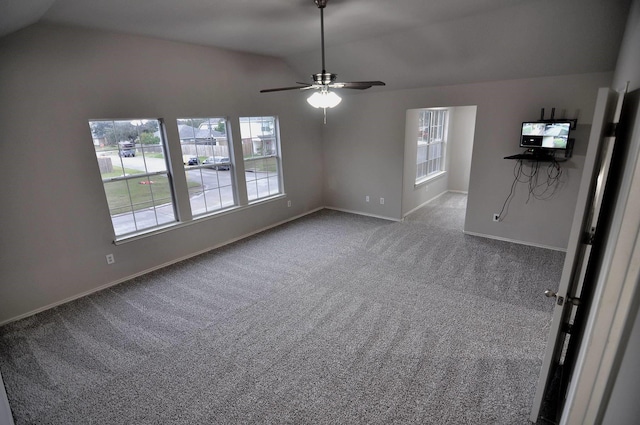 interior space featuring carpet, vaulted ceiling, and ceiling fan