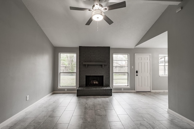 unfurnished living room with ceiling fan, lofted ceiling, and a fireplace