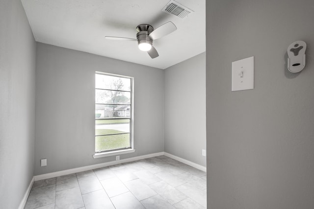 spare room with light tile patterned floors and ceiling fan