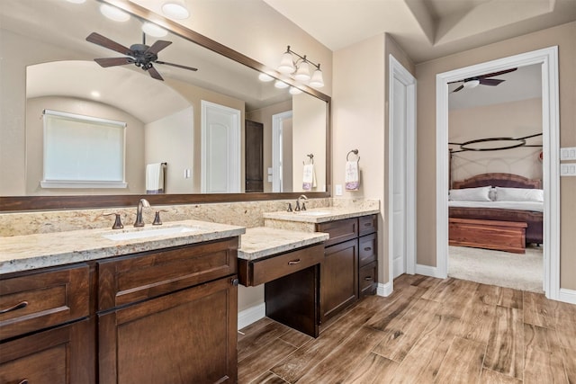 bathroom featuring ceiling fan, wood finished floors, and ensuite bath