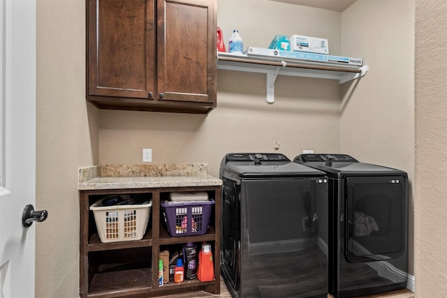 laundry room with cabinet space and washer and clothes dryer