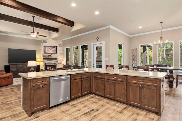 kitchen featuring open floor plan, a healthy amount of sunlight, dishwasher, and a sink