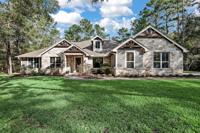 craftsman-style home featuring a front yard and a shingled roof