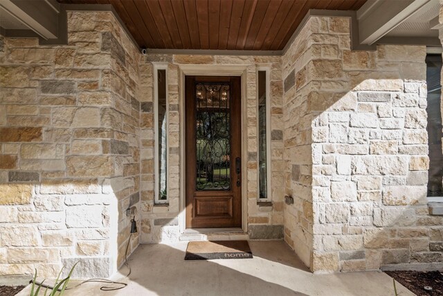 view of exterior entry featuring stone siding