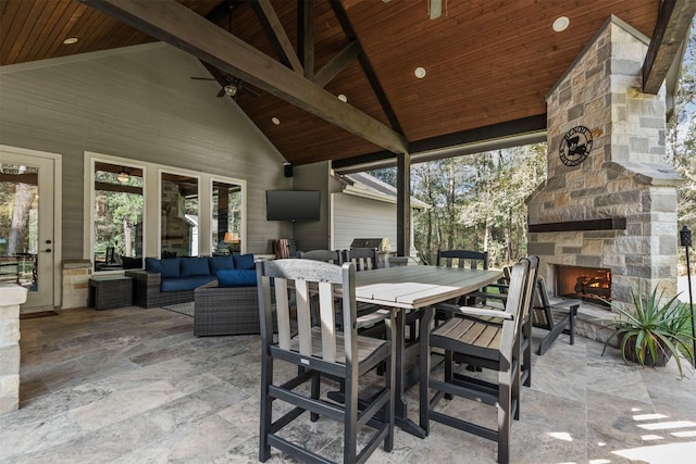 view of patio / terrace with an outdoor living space with a fireplace and outdoor dining area