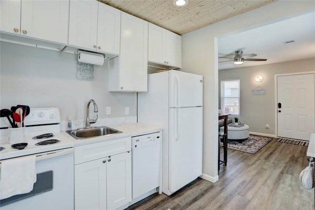 kitchen featuring white cabinetry, sink, white appliances, and light hardwood / wood-style flooring