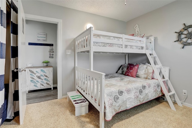 bedroom featuring carpet and a textured ceiling