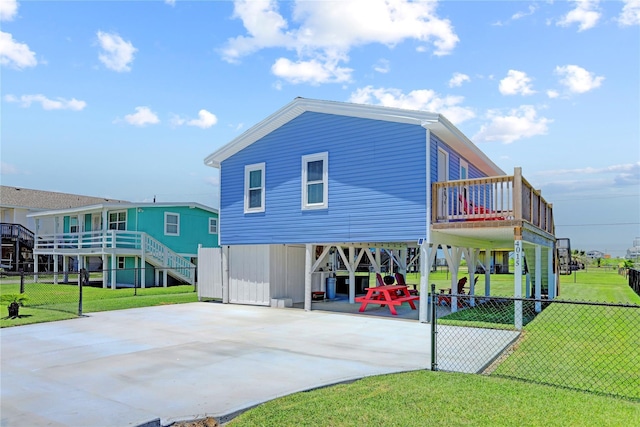 back of property featuring a carport and a yard