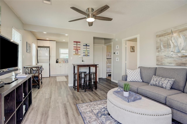 living room featuring ceiling fan and wood-type flooring