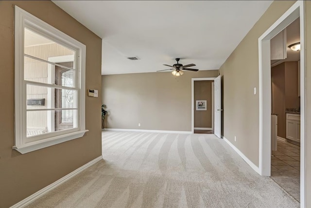 carpeted empty room with ceiling fan