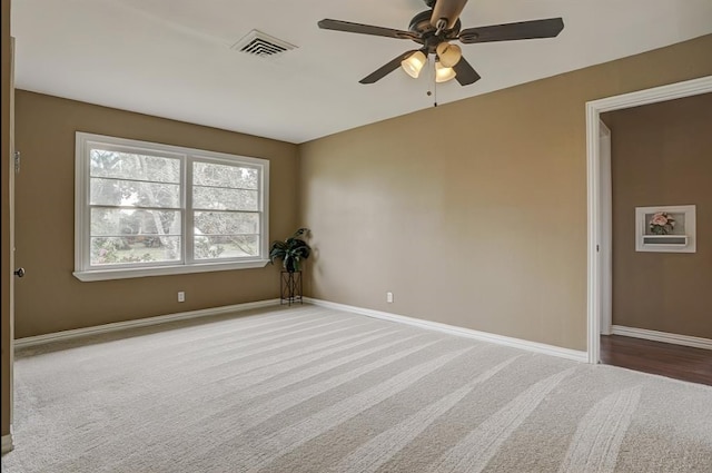 spare room with ceiling fan and carpet