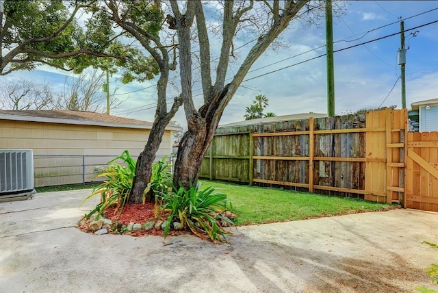 view of yard featuring central air condition unit and a patio area