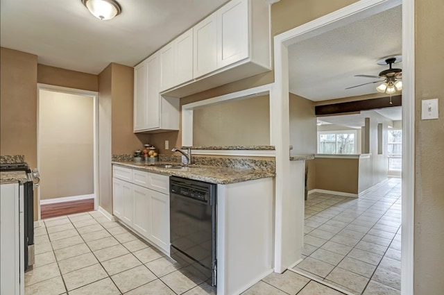 kitchen with sink, ceiling fan, black dishwasher, light stone counters, and white cabinetry