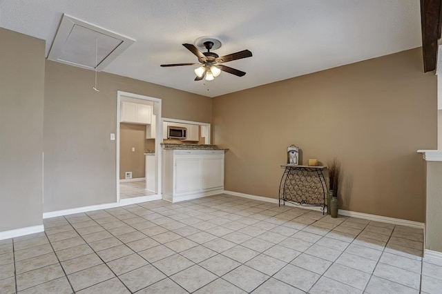 unfurnished room featuring ceiling fan and light tile patterned floors