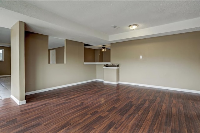 spare room featuring a textured ceiling, dark hardwood / wood-style floors, and ceiling fan