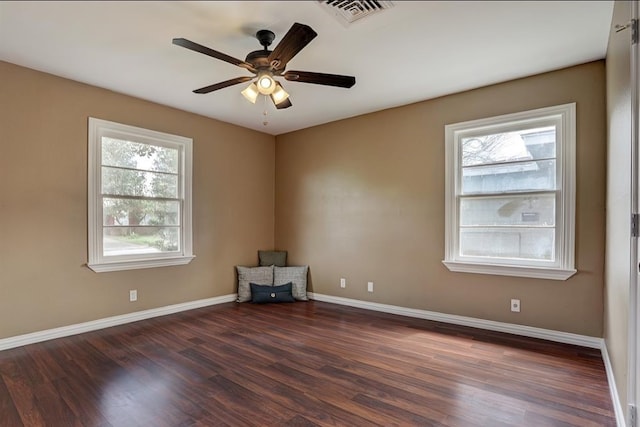 empty room with ceiling fan and dark wood-type flooring