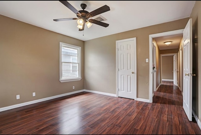 unfurnished bedroom featuring dark hardwood / wood-style floors and ceiling fan